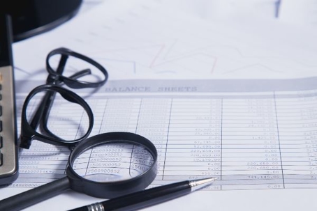Excel Spread sheet & Glasses on a desk